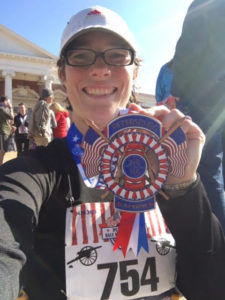 Heidi with half marathon medal