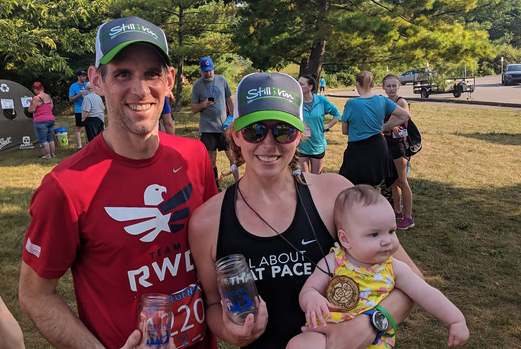 Sasha with her husband and daughter after running a race.