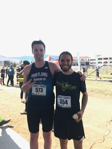Luke and Grant standing with race bibs after running a race