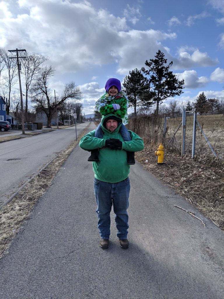 Patty's husband with daughter on his shoulders