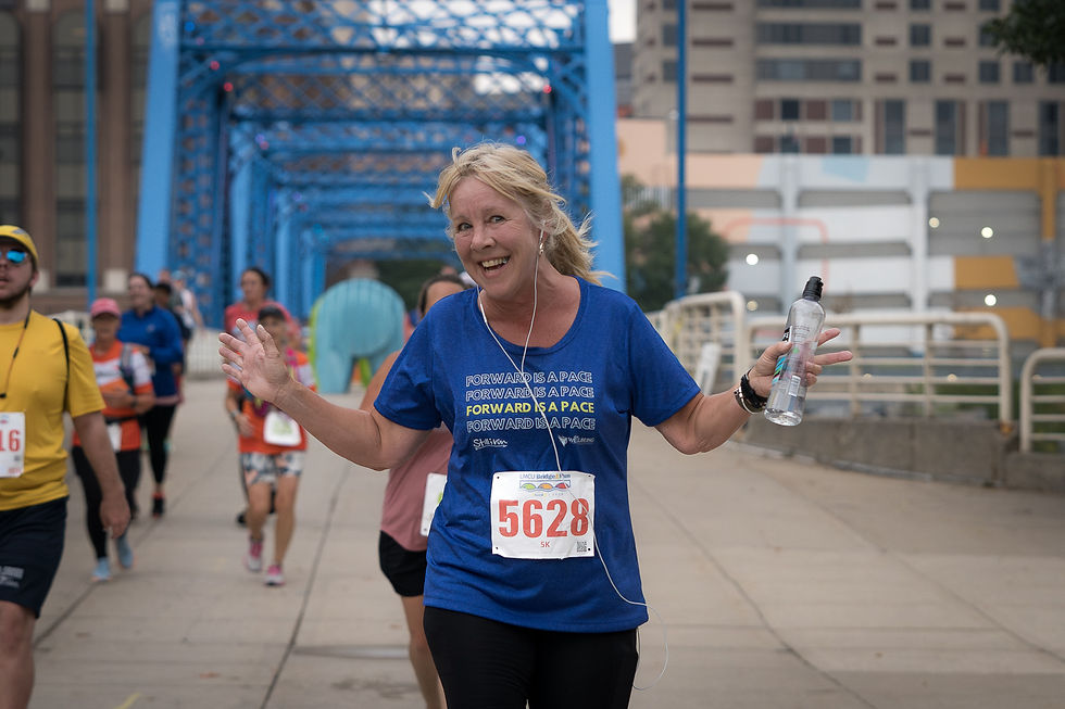 A woman running a 5K with a Still I Run tshirt on
