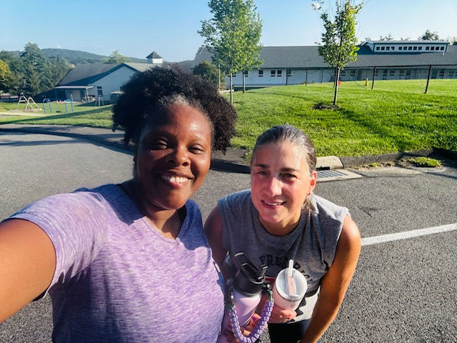 Two runners smiling and posing for a selfie