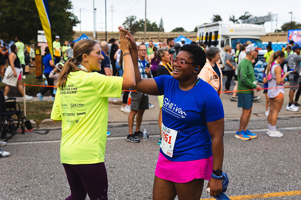 two people high-fiving after a race