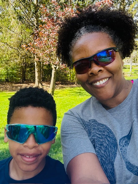 A mother and son posing for a selfie