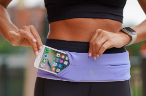 a person holding a flipbelt with their phone in it