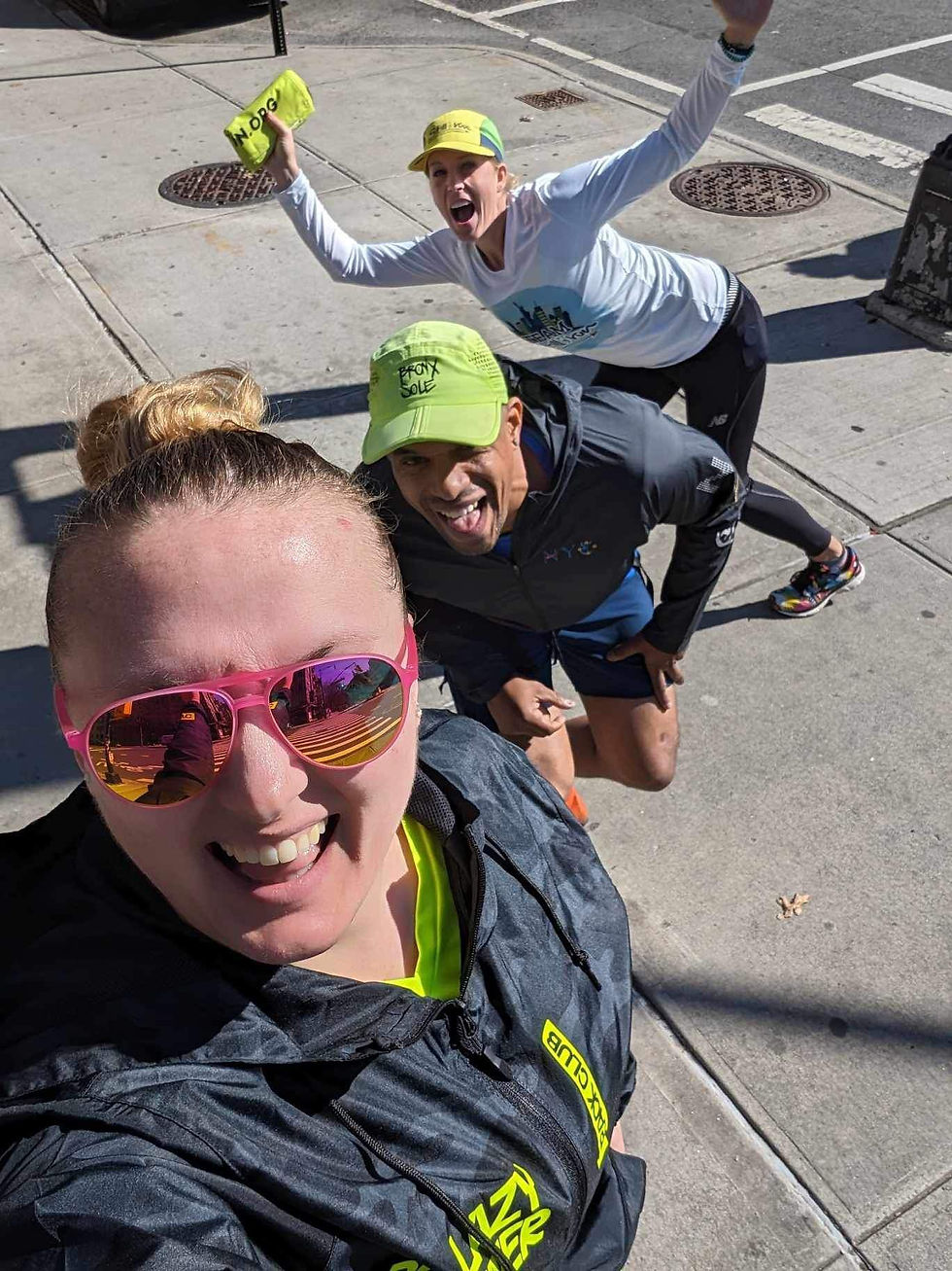 Runners posing together and celebrating during a race