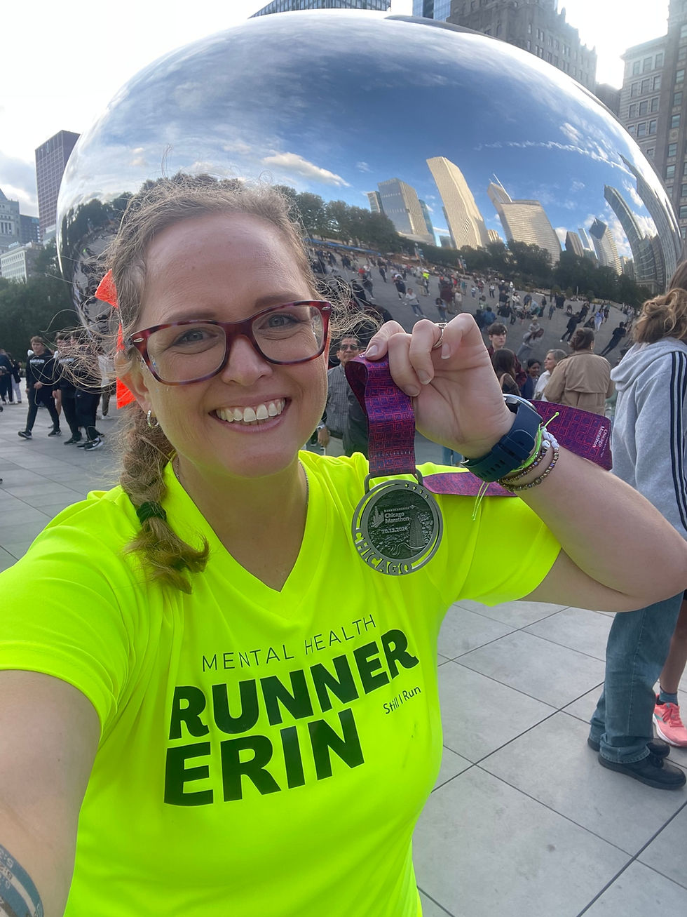 a runner showing off her medal from the Chicago marathon