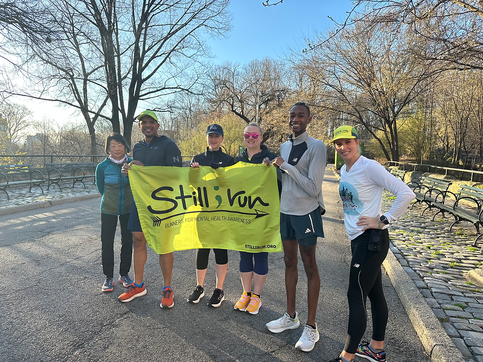 Runners holding the Still I Run banner