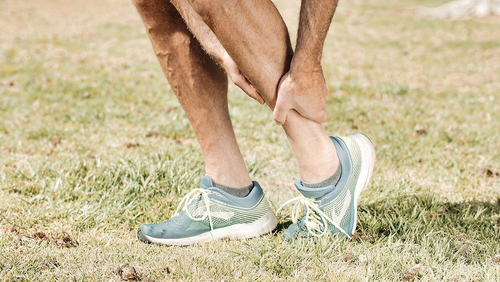 a person holding onto their lower calf muscle