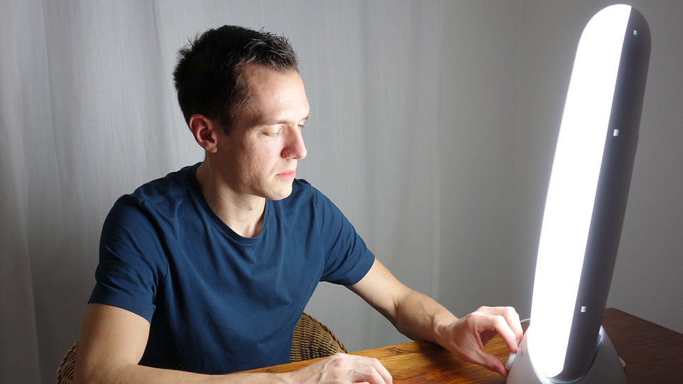 a man using a light therapy lamp