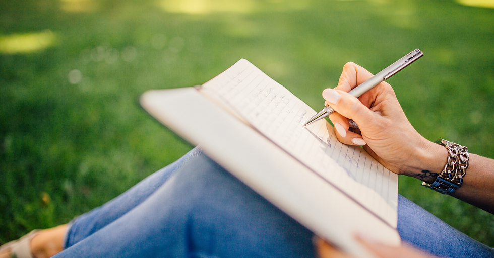 a person writing in a journal