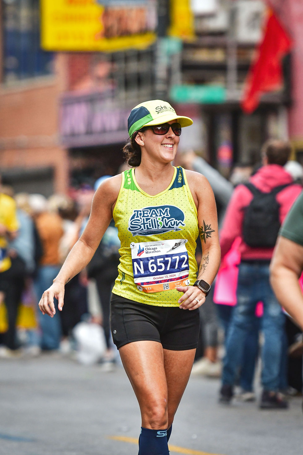 a person in a Team Still I Run running singlet during the Chicago Marathon