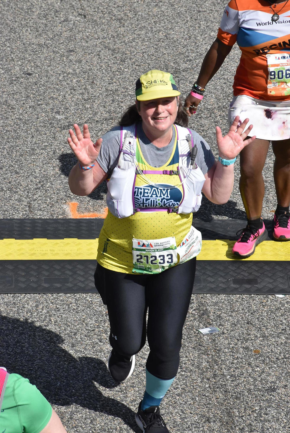 a woman wearing a hydration vest while running in the heat