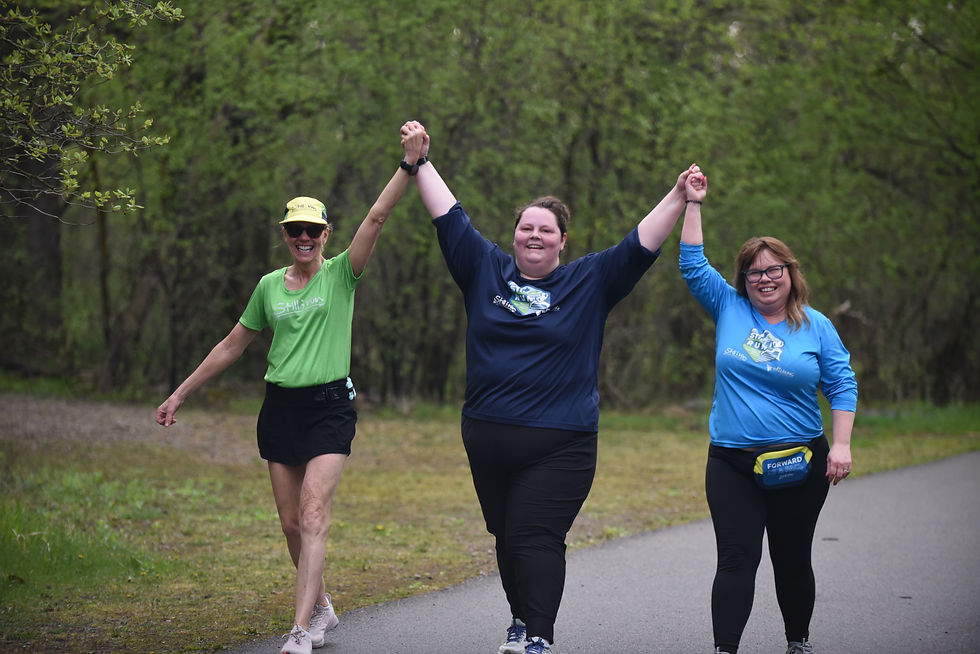 members of team still i run holding their hands up in the air