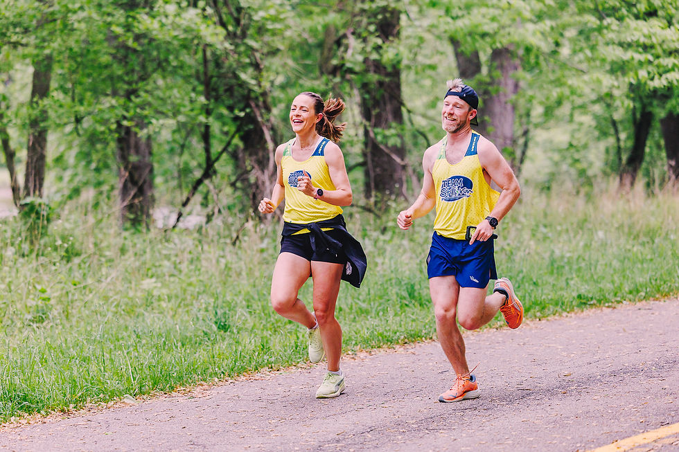 two people running along a shaded route