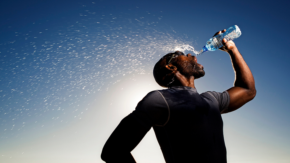 a runner drinking water on a long run
